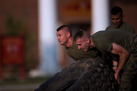 Aspiring Marines Lifting Tire During Physical Fitness Test Aspiring Marines Lifting Tire During Physical Fitness Test