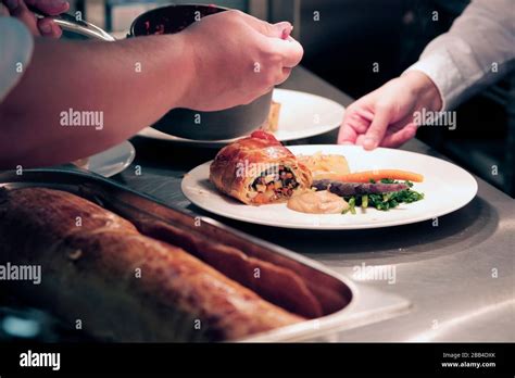 Chefs And Kitchen Staff At Work In The Kitchen At The Station Cafe Bar