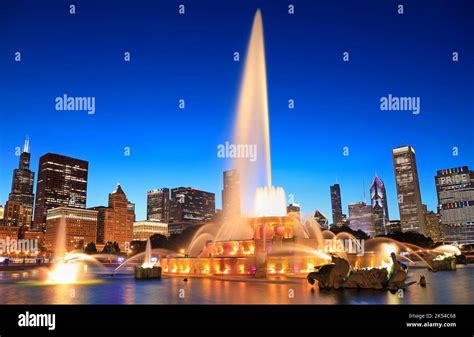 Chicago Skyline Illuminated At Dusk With Colorful Buckingham Fountain