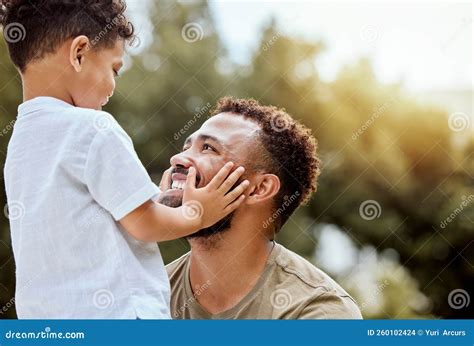 Dad Boy Touch Face In Outdoor Park Or Backyard For Summer Bonding