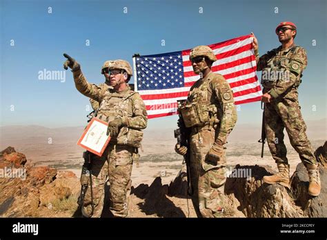U S Army Soldiers Hold The American Flag Atop Pride Rock Mountain In Afghantistan Stocktrek Images
