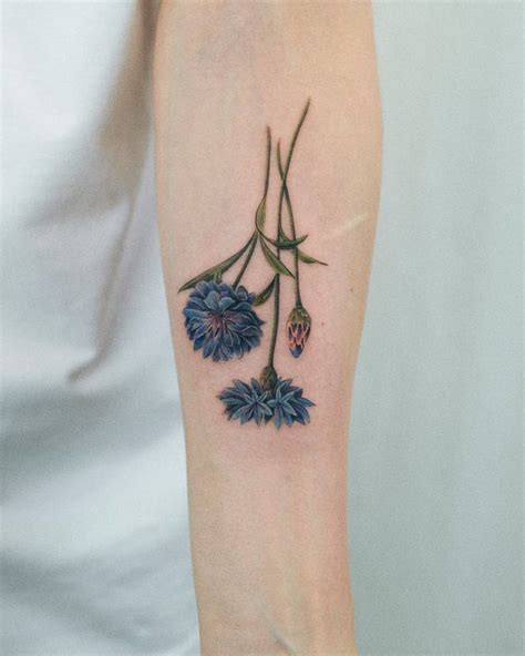 Watercolor Style Cornflower Tattoo Located On The